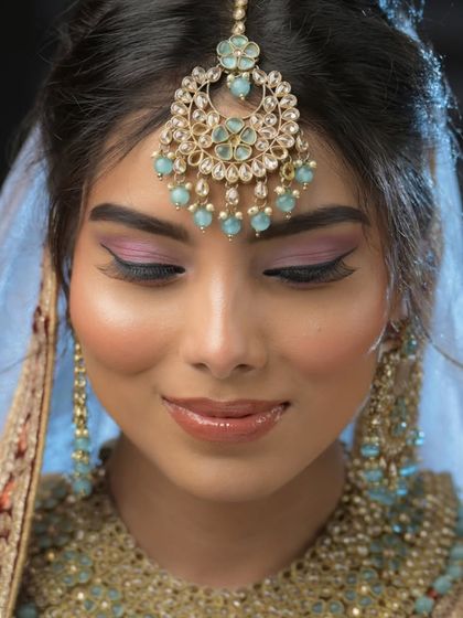 A soft and dreamy pastel bridal look. This demonstrates the ability to work with lighter color palettes for daytime weddings or modern brides.