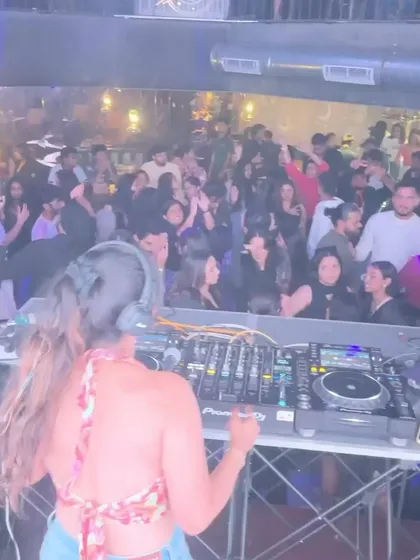 From behind, you can see how I watch and react to the crowd. Keeping people dancing is my number one priority, and I adjust my set based on the room's energy.
