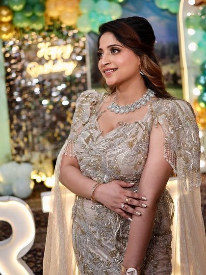 A profile shot showing the intricate details and flattering fit of the gown. The cape sleeves add a touch of modern drama.