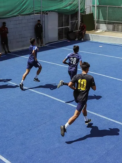 Speed and acceleration work on the blue turf. These drills are essential for creating separation on the field and reacting quickly to the play.