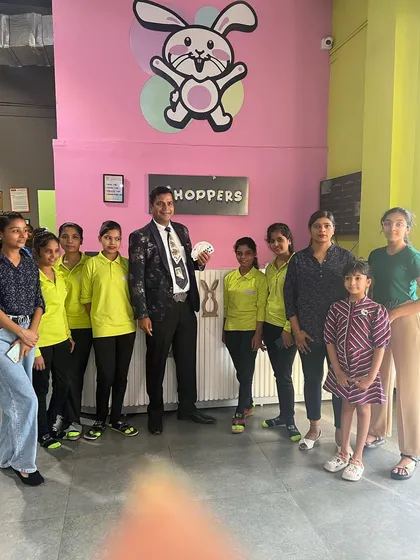 The magician posing with our dedicated Hoppers team after a fantastic show.