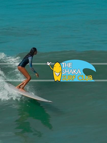 The title card for The Shaka Surf Club video, featuring a surfer gracefully riding a wave. This image sets the tone for a story about the surfing lifestyle and community.