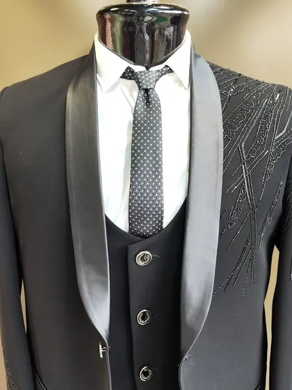 A collection of our designer suits, showcasing a variety of colors, fabrics, and custom details like embroidery, unique lapels, and accessories. Each piece is crafted to make a lasting impression.