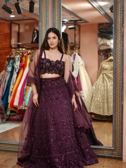 Dripping pure glamour. This deep purple lehenga with a unique floral bustier is stitched to slay.