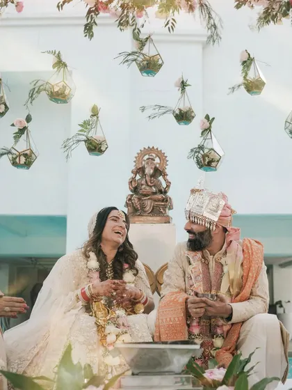 A moment of pure, unscripted laughter during an intimate wedding ceremony in Alibaug. This candid shot captures the couple's joy and the relaxed atmosphere of their special day.