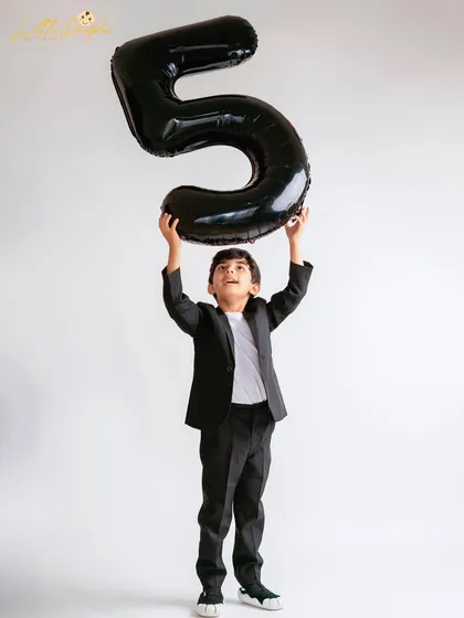 Reaching for the stars, or at least the number five. This shot captures the energy and excitement of being a big kid.