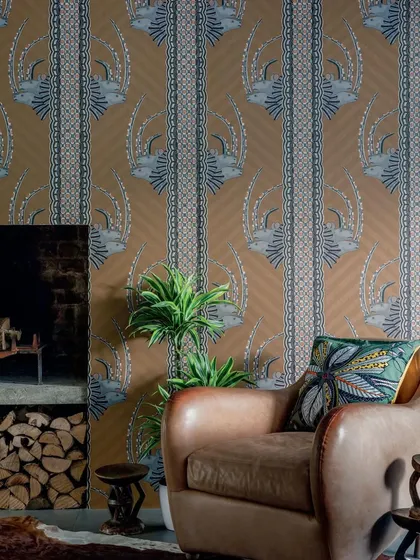 The "Jabu" wallpaper by Cole & Son, which celebrates African artistry with regal white rhinos set within vibrant vertical stripes. This design brings a unique story of heritage and elegance to the walls.