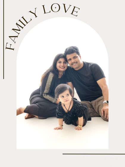 A beautifully framed family portrait with an arch design. The baby crawling in the foreground adds a dynamic and sweet element to this studio shot.
