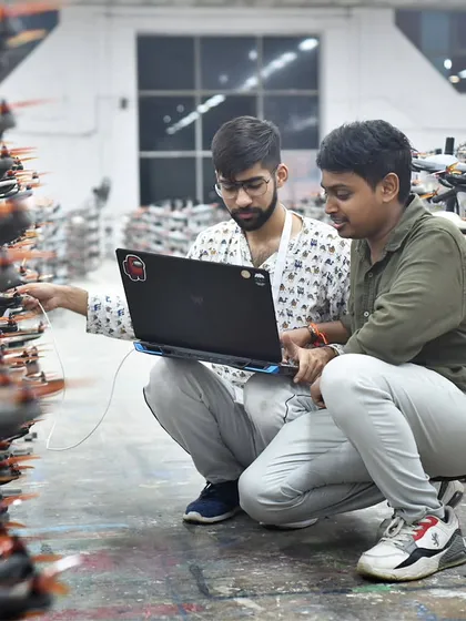 Behind every show is our team of dedicated engineers. This photo from our workshop shows the collaboration and problem-solving that goes into programming thousands of drones for a single performance.