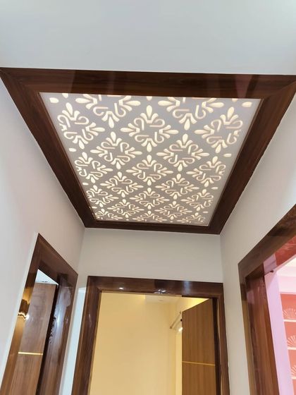 A close-up of the backlit CNC jali panel in the foyer ceiling. This is a great way to add a decorative lighting element to your entrance area.