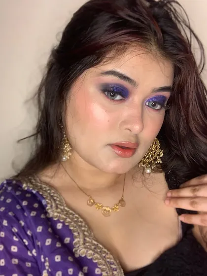 This image captures the rich pigment and sparkle of the purple eyeshadow.