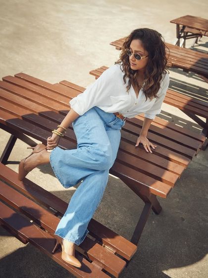 This shot captures the full casual-chic look, from the relaxed jeans to the stylish nude pumps.
