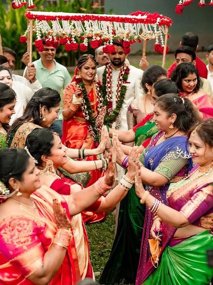 The bride and groom's procession, with female family members leading the way in a traditional welcome.