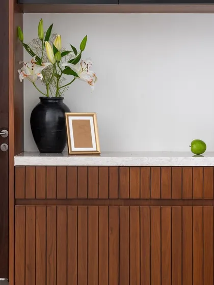 This dining unit in 'Living life in colours' cleverly integrates a puja space. A sliding glass panel reveals the sacred alcove while maintaining a sleek look when closed.
