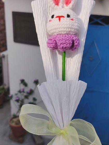 This cute bunny bouquet was created as a custom order for birthday return gifts. It features a small amigurumi bunny head nestled in a flower, individually wrapped for a unique party favor.