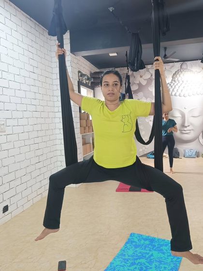 Finding a wide-legged stance with the support of the hammock helps to build confidence and strength in the lower body.