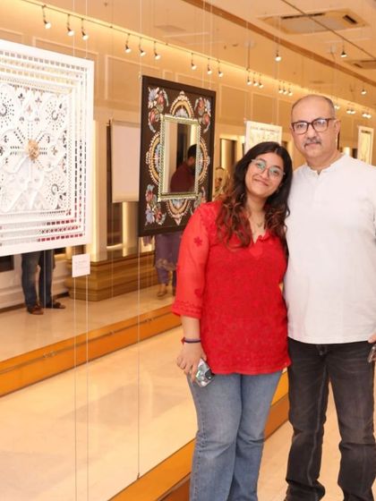 A family enjoying the 'Aaina' exhibition together, a testament to art bringing people together.