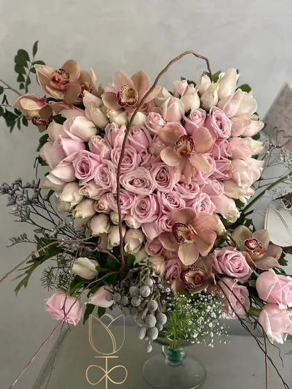 My Valentine's Day bestseller. A heart-shaped arrangement of soft pink roses, accented with delicate cymbidium orchids. It's a romantic and elegant way to express your love.