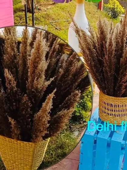 A close-up of the pampas grass arrangements used in the Haldi carnival decor, adding a touch of rustic chic to the vibrant setup.
