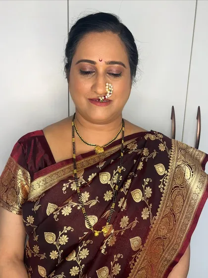 The makeup details for Kasturi's Mangalagaur look. The soft gold eyeshadow and defined brows enhance her features beautifully without feeling heavy.