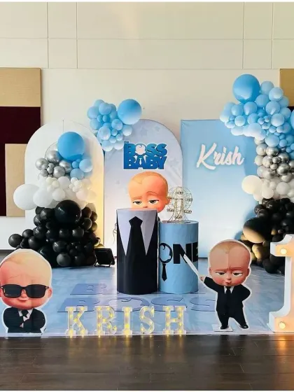 A cool and fun Boss Baby themed first birthday for Krish. This decoration features character cutouts, a light-up marquee number '1', and a sleek blue, black, and silver color scheme.