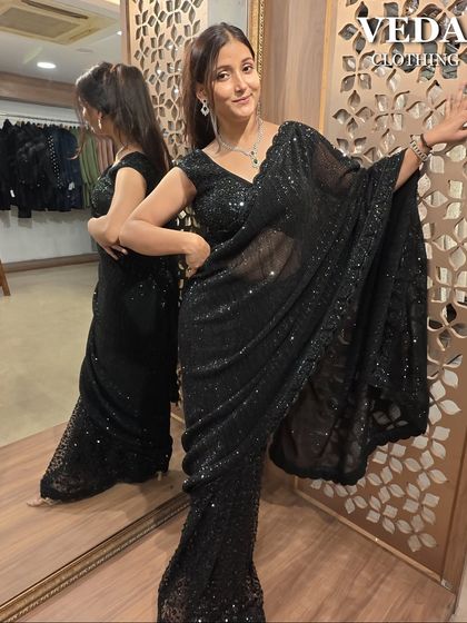 A playful and confident pose in the black sequined saree. It's the perfect pre-loved outfit to dance the night away in.