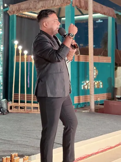 A side profile shot on stage, showing how I command the space. The right outfit, like this sharp jacket, gives me the confidence to own the stage.