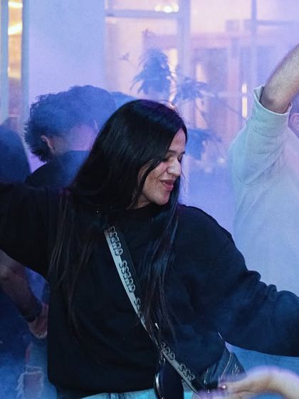 A candid shot of someone lost in the moment on the dancefloor.