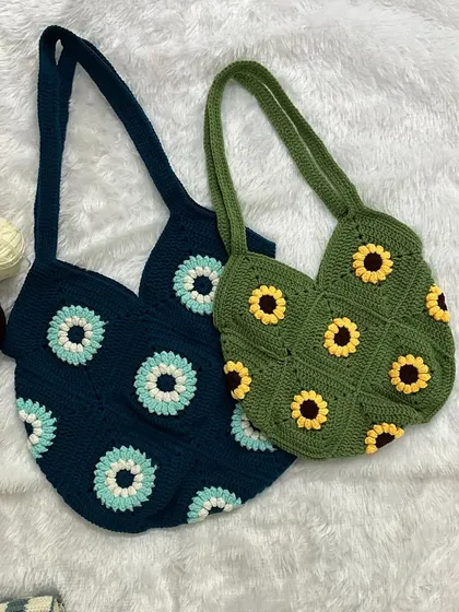 I make a variety of handmade tote bags, each with its own personality. Here you can see two of my granny square designs: a sunflower tote in olive green and a floral pattern in deep blue.