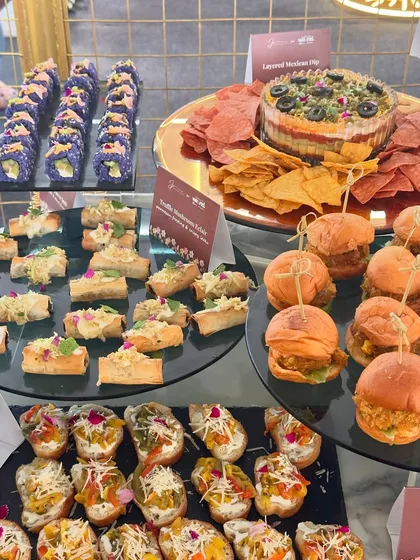 A wide array of our appetizers, including sliders, crostini, sushi, and layered Mexican dip, at the Ajio Luxe Weekend.