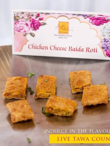 Indulge in the flavors of our live tawa counters. This image showcases our delicious Chicken Cheese Baida Roti, prepared fresh on the griddle for a savory, melt-in-your-mouth appetizer.