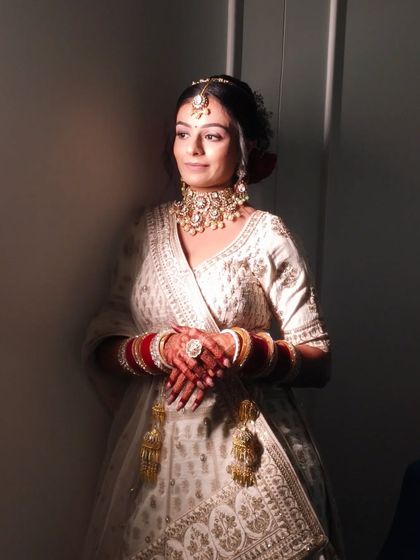Another artistic shot showing the play of light and shadow on the bride's face, emphasizing the flawless makeup application.