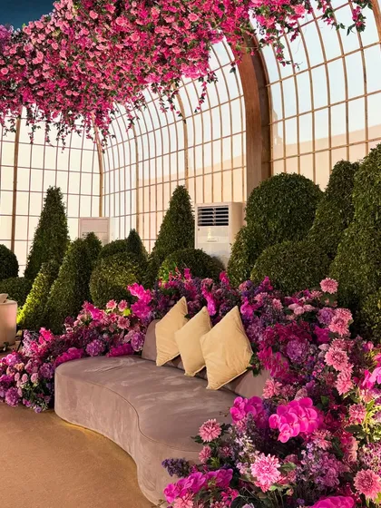 A melange of florals in the most aesthetic burst of hues. This comfortable lounge sofa is nestled within a garden of purple and pink flowers, creating a perfect photo-op. 🩷💜