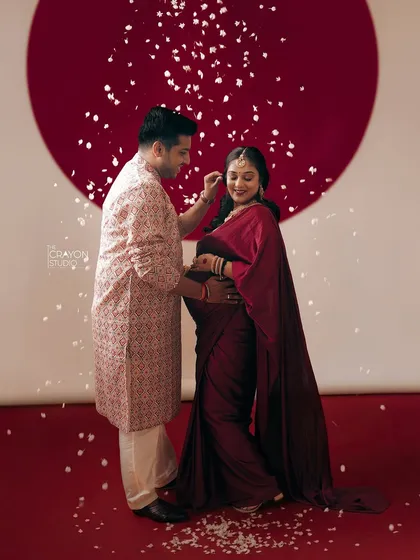A tender moment between the couple, as he gently adjusts her hair. These small gestures of care and connection are what make a couple's maternity photoshoot so special.