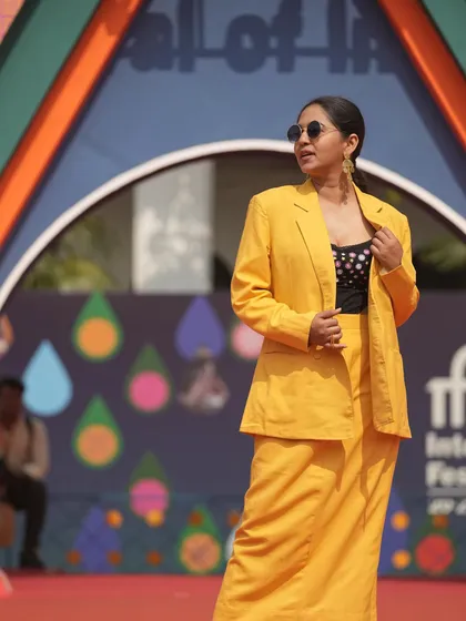 Mrunmayee Deshpande owning the red carpet at the International Film Festival of India in a custom-designed yellow blazer and skirt. The look is modern, powerful, and chic.