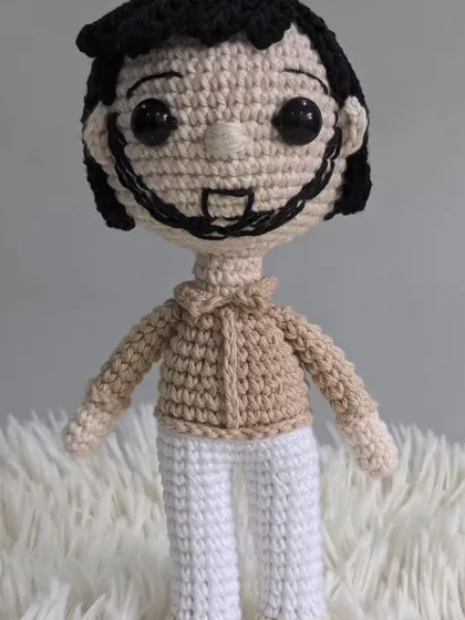 A close-up of a custom male doll, part of a larger family set. The details in the hair, beard, and clothing are all personalized.