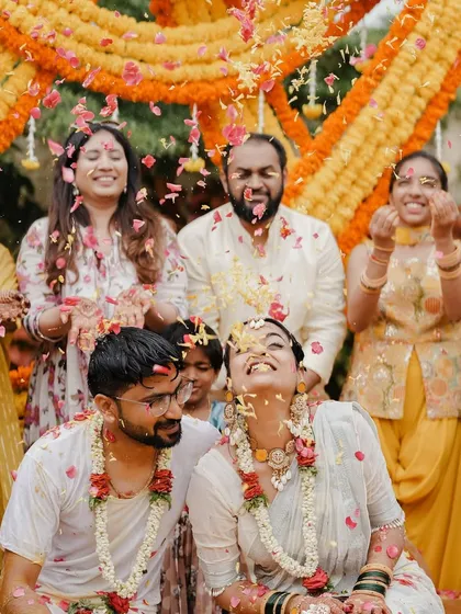 The pure joy of a Haldi ceremony is unmatched. We love creating vibrant, fun-filled settings where couples and their families can make memories, like this moment where Ketaki and Rakesh were showered with love and flower petals.