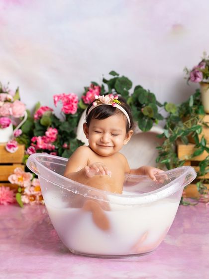 A shy, happy smile from this little one in her pink floral bath. Even the quiet moments are full of beauty and emotion.