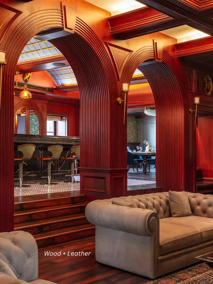 Wood + Leather: This pairing creates a sense of warmth and tactility. In this Irish-style bar, rich wood paneling is combined with classic leather seating for a cozy and inviting feel.