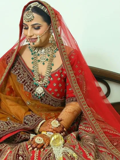 A seated portrait of the bride, looking elegant and poised in her full wedding ensemble.