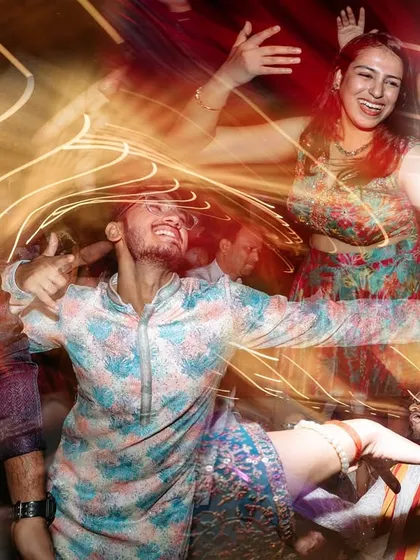 The energy of a sangeet night is electric. We use creative techniques like slow shutter speeds to capture the blur of motion and the peak of celebration, turning a dance into a vibrant work of art.