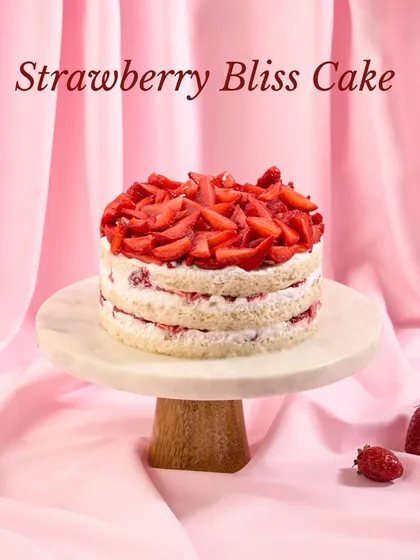 An elegant shot of our Strawberry Bliss Cake, perfect for celebrations. We use a simple, fresh aesthetic to let the quality of the ingredients shine.