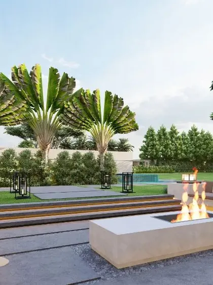 A render of an intimate sunken seating area with a modern fire pit, set against a backdrop of traveler's palms. This design is perfect for cool evenings, offering a cozy gathering spot surrounded by lush greenery and the sound of water.