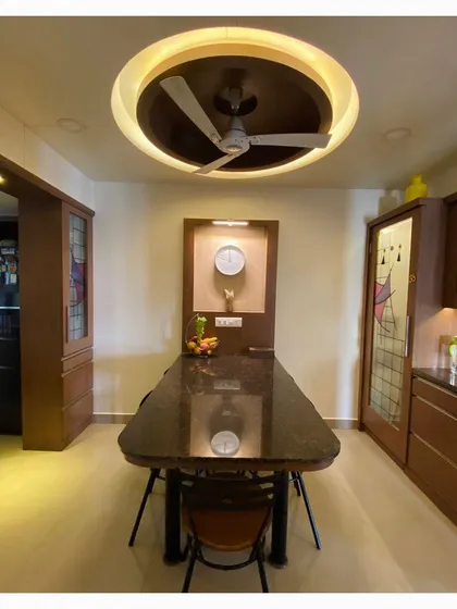 This image highlights the custom lighting and wall niche in the dining space, creating a focal point and adding functional elegance.