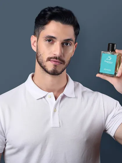 A male model holds up a perfume bottle, presenting it directly to the camera. This clean, straightforward shot is excellent for e-commerce product listings.