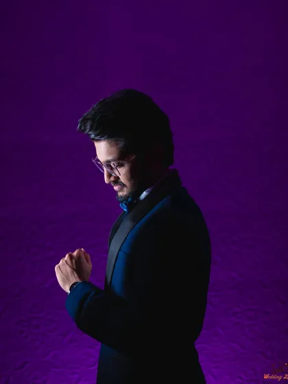 A stylish portrait of the groom, Vivek, using colored lighting to create a modern and sophisticated look. It's important to capture the groom's style and personality too.