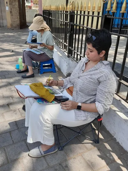 Here I am, focused on my sketch of Metro Cinema during an urban sketchers meet-up. Live sketching requires concentration and a quick hand to capture the scene.