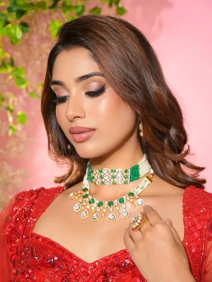 Main character energy for the sister of the groom. This soft glam look in red is powerful yet elegant, with a focus on winged liner and a flawless complexion.