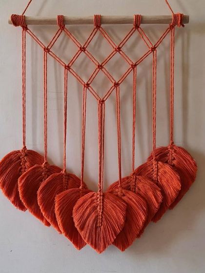 A different style of leaf wall hanging, this one featuring a diamond-patterned top and a neat arrangement of orange leaves.