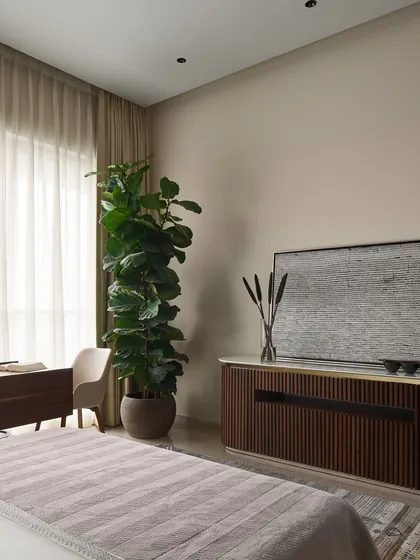 Here, the fluted wood console with a built-in music system complements the multifunctional study table. Every piece in this master bedroom is custom-designed to work together, creating a cohesive space that balances technology, creativity, and relaxation.